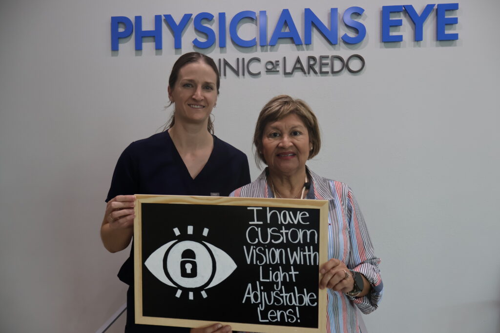 Erin Lewis, NP with a patient holding a sign that reads “I have custom vision with Light Adjustable Lens” at Physicians Eye Clinic of Laredo.