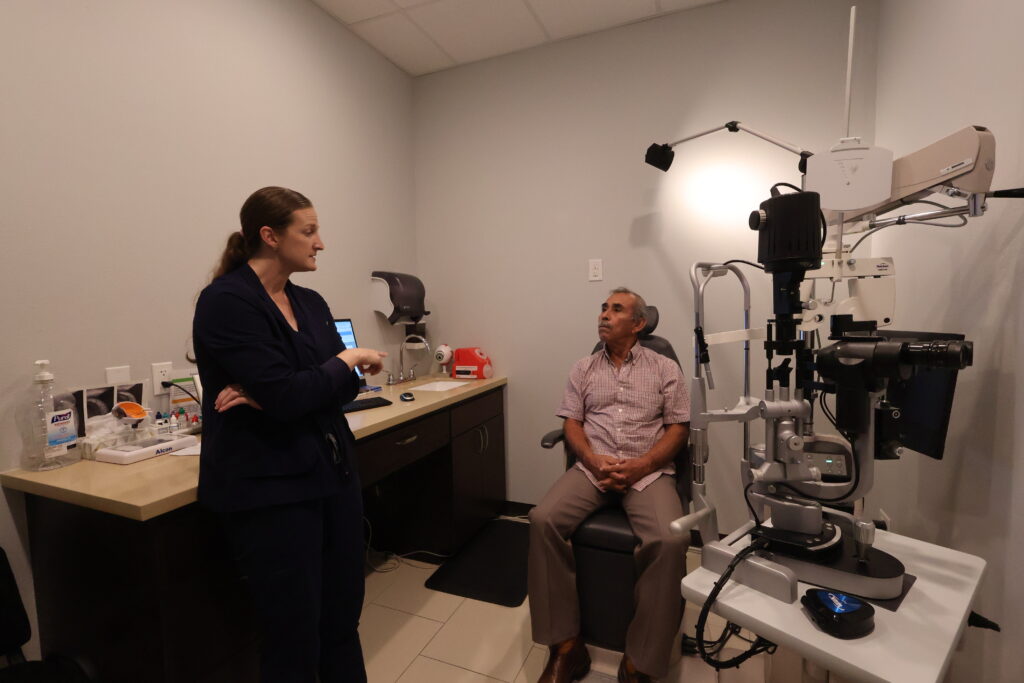 Erin Lewis, MSN, APRN, FNP-C, Nurse Practitioner at Physicians Eye Clinic of Laredo, speaking with a patient during an eye care consultation.